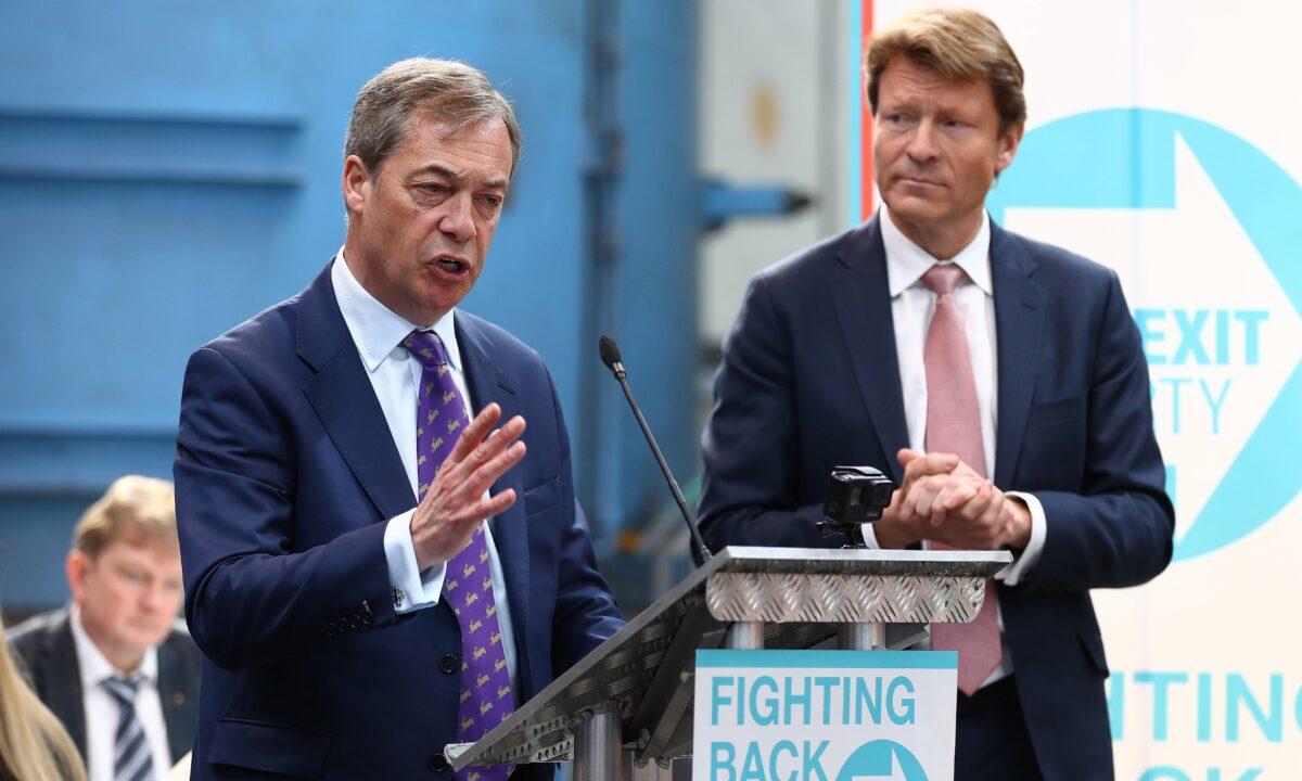 Richard Tice (R) listens as Nigel Farage speaks during the launch of the Brexit Party at BG Penny & Co, in Coventry, England, on April 12, 2019. (Matthew Lewis/Getty Images)