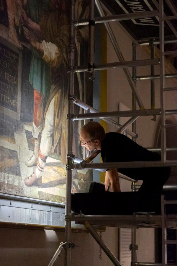 A Victoria and Albert Museum conservator checks the condition of a Raphael cartoon. (Victoria and Albert Museum, London)