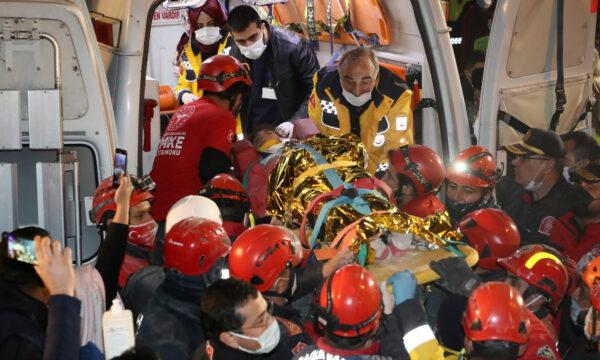 Rescue workers, who were trying to reach survivors in the rubble of a collapsed building, carry to an ambulance 14-year-old Idil Sirin who have been extricated from a collapsed building early Monday, 58 hours after a strong earthquake, in Izmir, Turkey, on Nov. 2, 2020. (AFAD via AP)