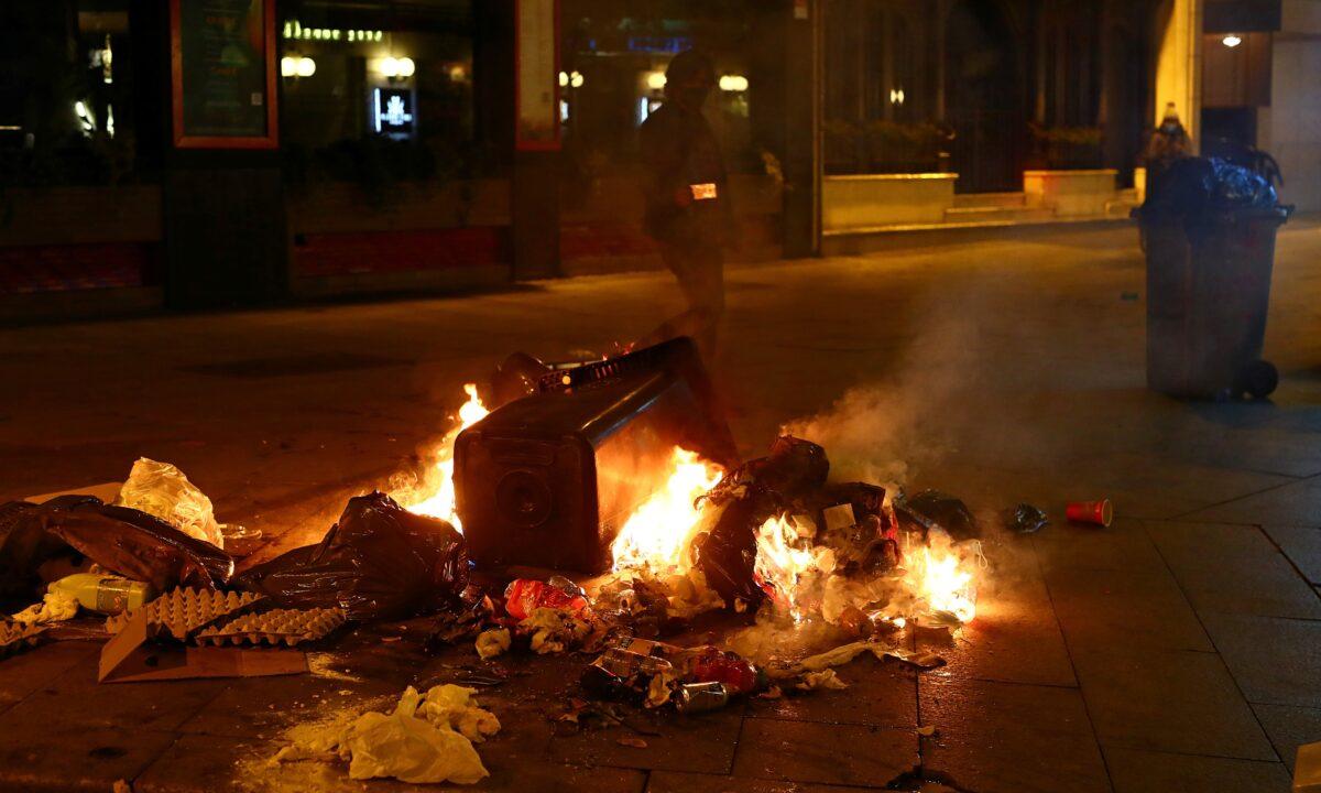  A rubbish bin and other objects are seen on fire during a protest against the closure of bars and gyms, amidst the CCP virus outbreak, in Madrid, Spain, on Nov. 1, 2020. (Javier Barbancho/Reuters)
