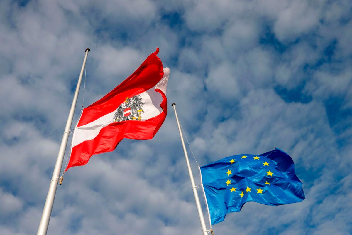 An Austrian and an EU flag fly at half-mast at the Austrian embassy in Berlin on Nov. 3, 2020. (Odd Andersen/AFP via Getty Images)