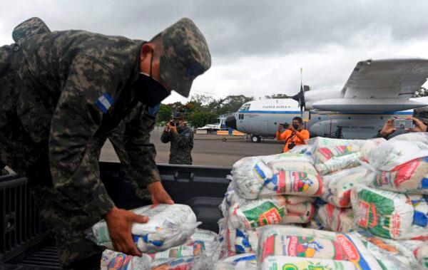  Honduran Air Force members load supplies on planes, to be taken to residents of Puerto Lempira municipality, department of Gracias a Dios, in preparation for the arrival of the upcoming Hurricane Eta, in Tegucigalpa, on Nov. 2, 2020. (Orlando Sierra/AFP via Getty Images)
