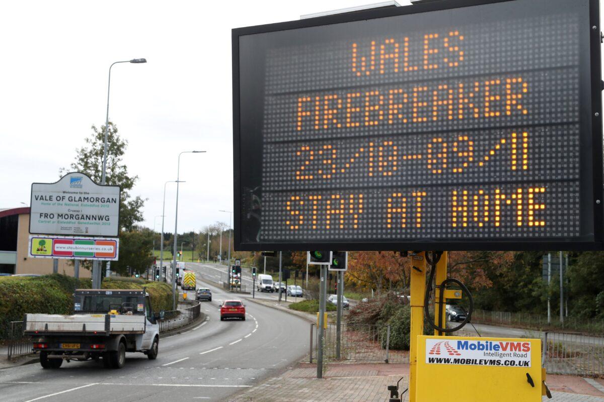 Traffic passes a COVID-19 sign informing drivers of the "firebreak" lockdown on Oct. 23, 2020, in Cardiff. (Geoff Caddick/AFP via Getty Images)