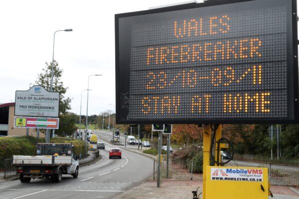 Traffic passes a COVID-19 sign informing drivers of the "firebreak" lockdown on Oct. 23, 2020 in Cardiff. (Geoff Caddick/AFP via Getty Images)