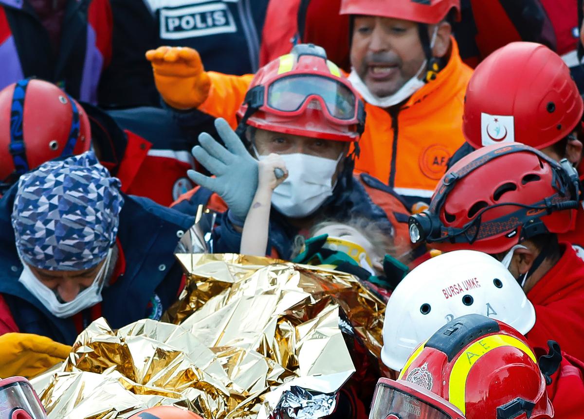 Members of various rescue services carry 3-year-old girl Elif Perincek after she was rescued from the rubble of a building some 65 hours after a magnitude 6.6 earthquake in Izmir, Turkey, Nov. 2, 2020. (Istanbul Fire Authority via AP)
