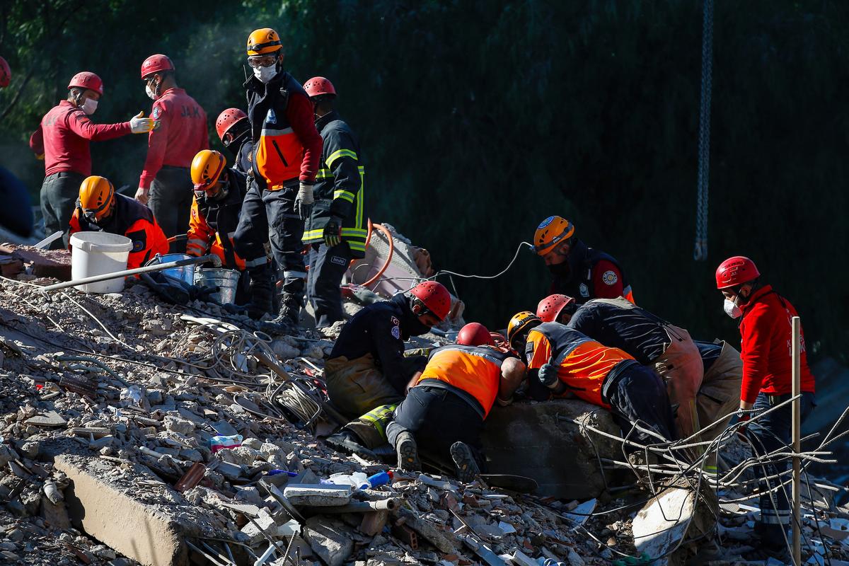 Members of rescue services work as they search for survivors in the debris of a collapsed building in Izmir, Turkey, Nov. 2, 2020. (Emrah Gurel/AP Photo)