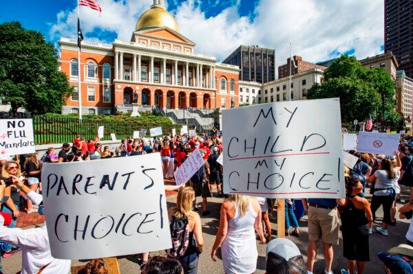 Hundreds of people protest a mandate from the Massachusetts governor requiring all children in grades K–12 to receive an influenza shot to attend the 2020–2021 school year, outside the Massachusetts State House in Boston on Aug. 30, 2020. (Joseph Prezioso/AFP via Getty Images)