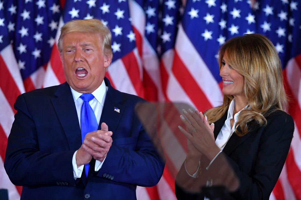 President Donald Trump claps alongside First Lady Melania Trump after speaking during election night in the East Room of the White House in Washington, early on Nov. 4, 2020. (Mandel Ngan/AFP via Getty Images)