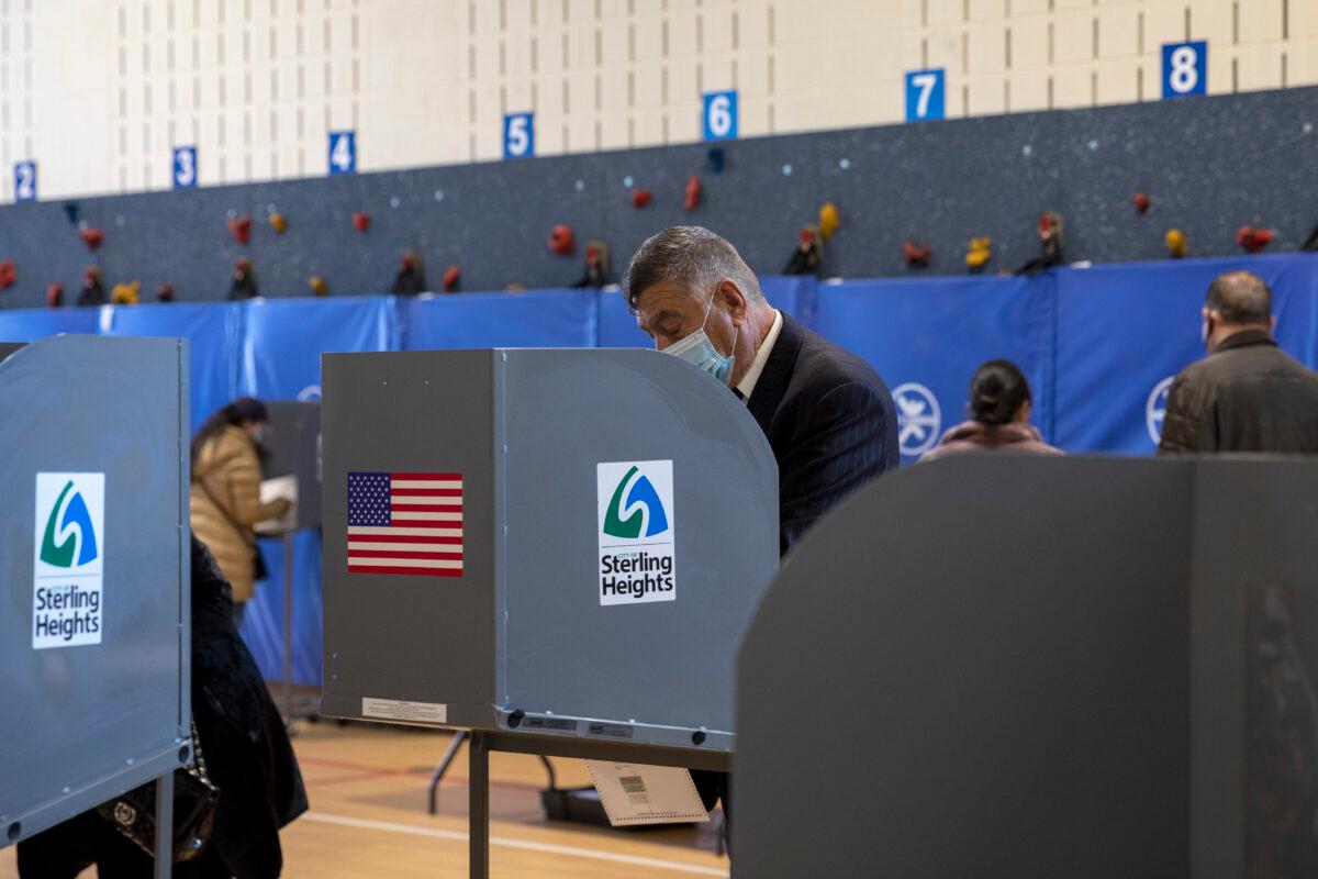 A person wearing a mask votes at Jefferson Elementary School in Sterling Heights, Mich., on Nov. 3, 2020. (Elaine Cromie/Getty Images)