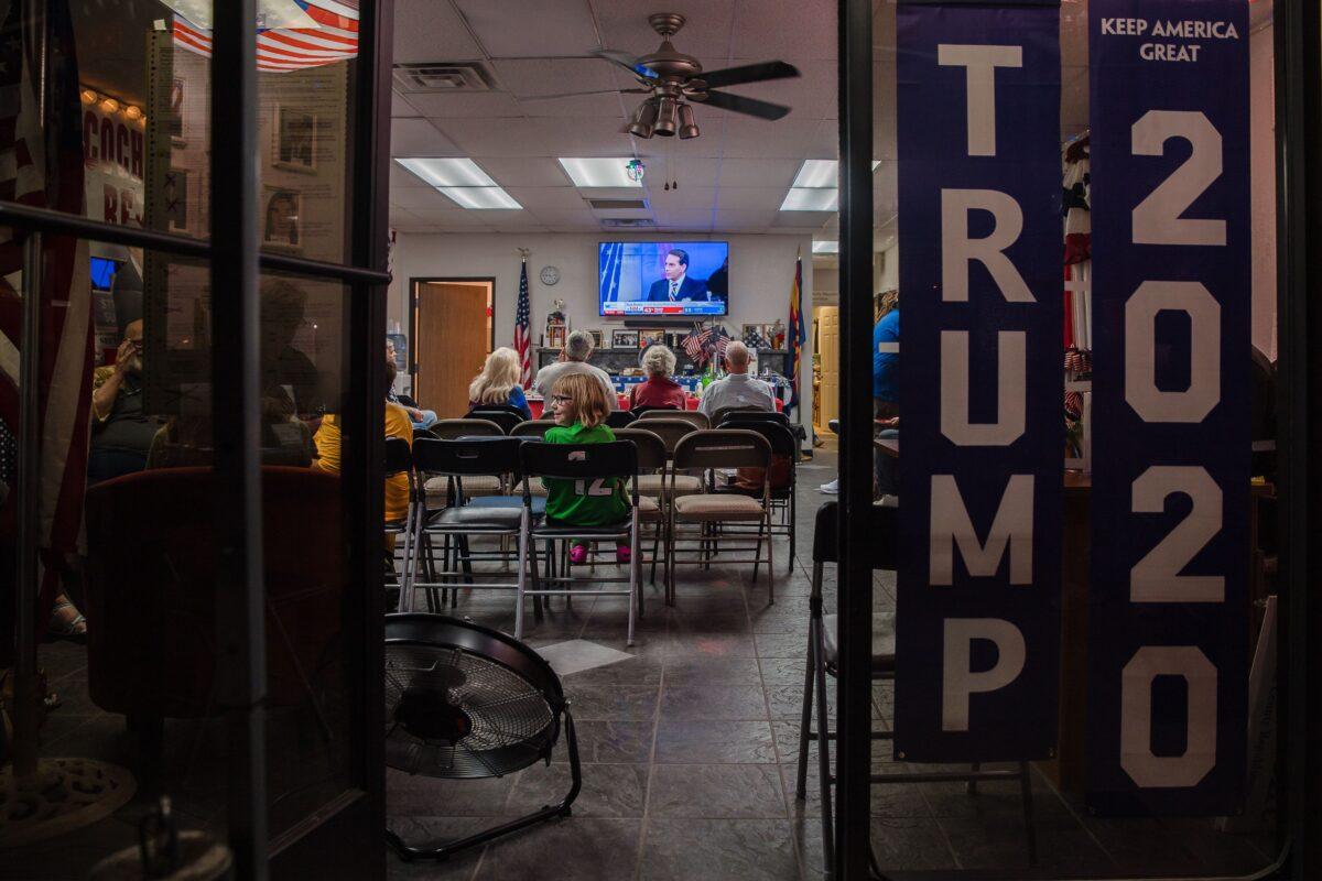 Supporters of US President Donald Trump watch the television to see the numbers coming in at the Cochise County Republican Headquarters in Sierra Vista, Ariz., on Nov. 3, 2020. (Ariana Drehsler/AFP via Getty Images)