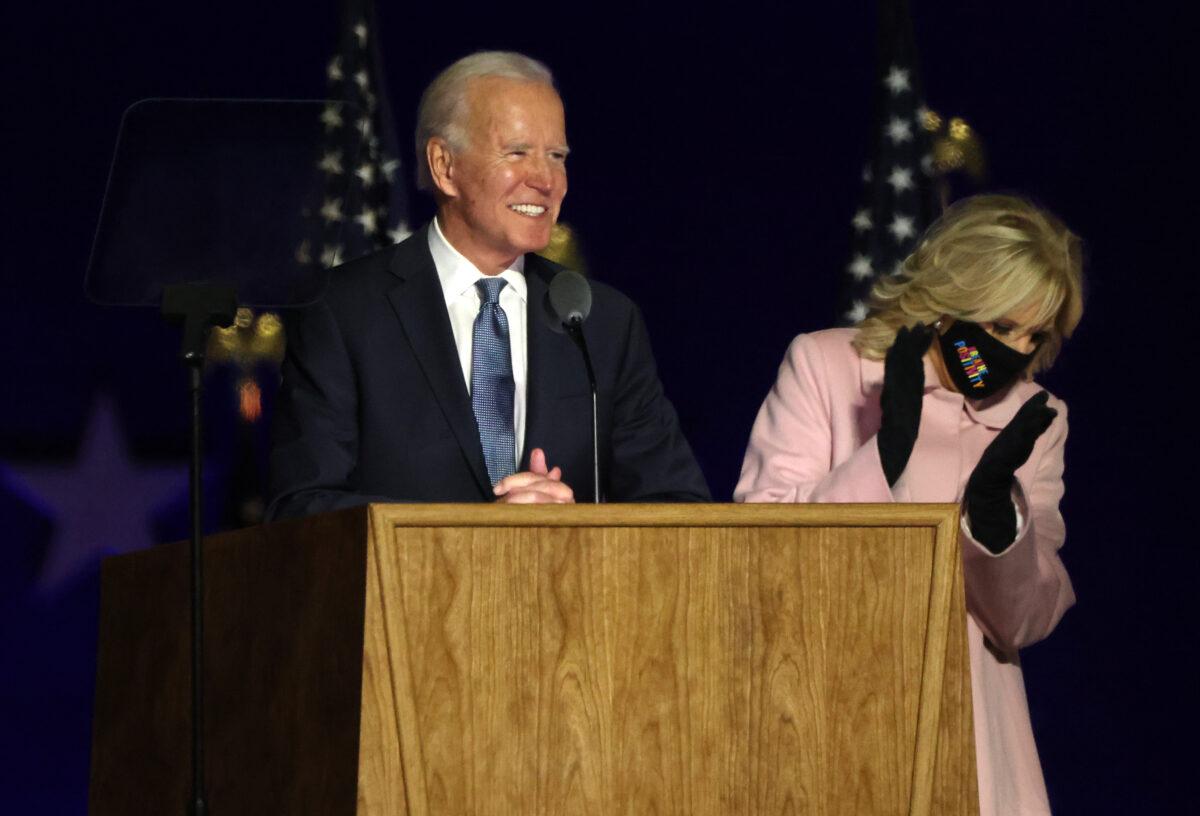  Democratic presidential nominee Joe Biden speaks at a drive-in election night event, with his wife Jill Biden clapping, at the Chase Center in Wilmington, Del., early Nov. 4, 2020. (Win McNamee/Getty Images)