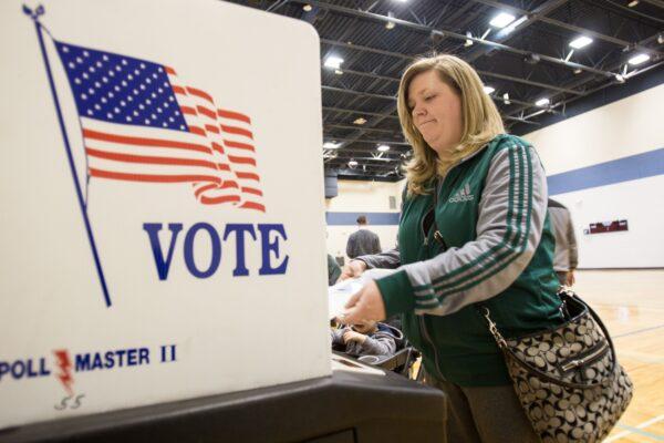 A voter casts her ballot for the Michigan presidential primary at a polling station in Warren, Mich., on March 8, 2016. (Geoff Robins/AFP via Getty Images)