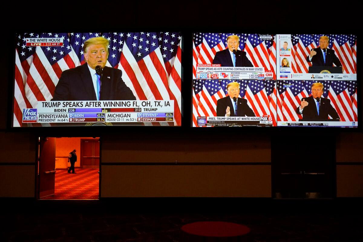 A live broadcast of President Donald Trump speaking from the White House is shown on screens at an election night party in Las Vegas on Nov. 3, 2020. (John Locher/AP Photo)