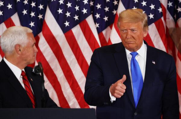 President Donald Trump gestures to Vice President Mike Pence on election night in the East Room of the White House in Washington in the early morning hours of Nov. 4, 2020. (Chip Somodevilla/Getty Images)