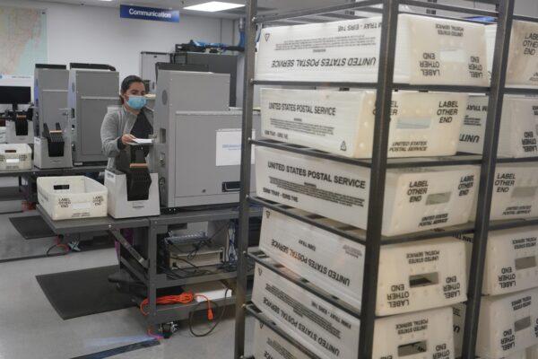 A worker scans and tabulates ballots at the Miami-Dade County Elections Department in Doral, Fla., on Nov. 3, 2020. (Wilfredo Lee/AP Photo)