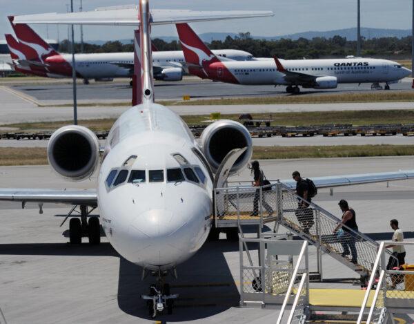 Passengers board a Qantas Boeing 717 at Perth International Airport on Oct. 31, 2011. (Torsten Blackwood/AFP via Getty Images)