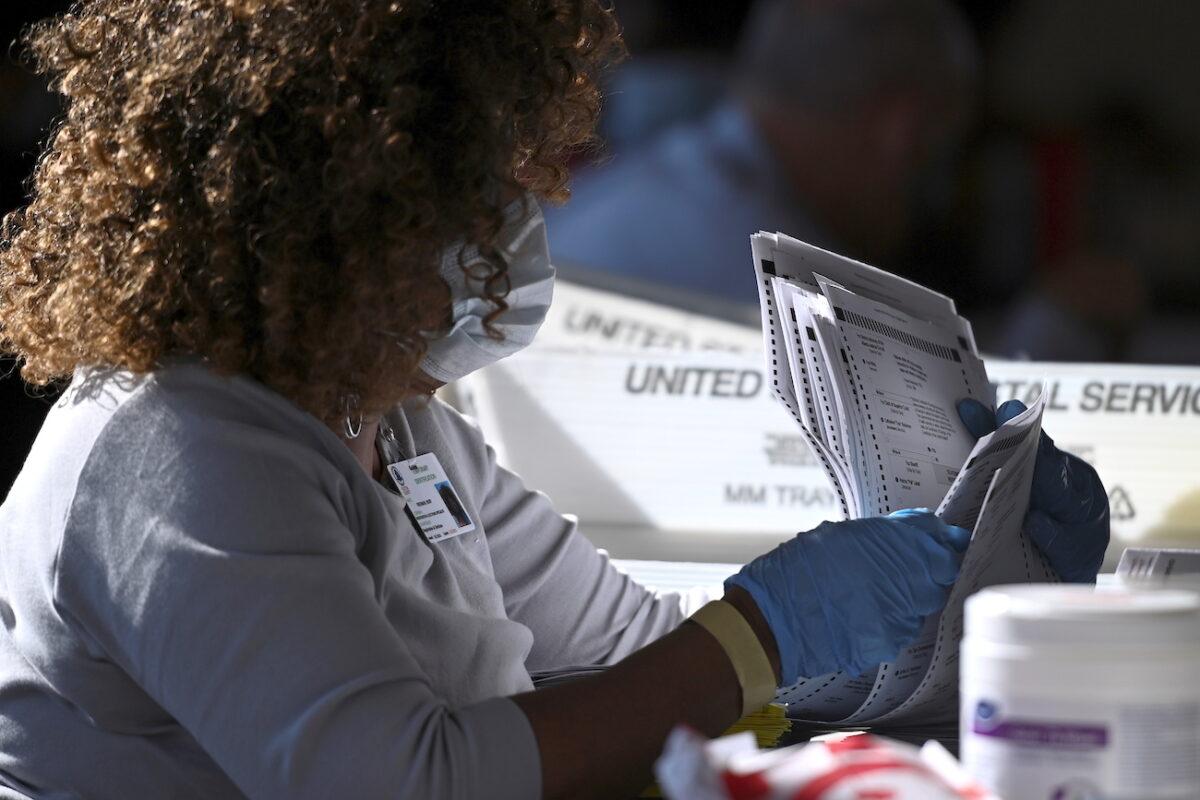 An employee of the Fulton County Board of Registration and Elections processes ballots in Atlanta, Ga., on Nov. 4, 2020. (Brandon Bell/Reuters)