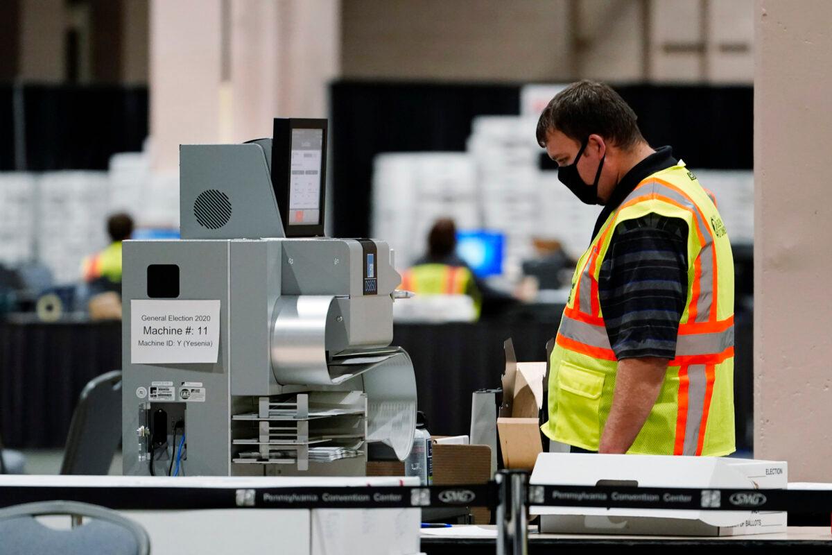 A Philadelphia election worker scans ballots for the 2020 general election in the United States at the Pennsylvania Convention Center, in Philadelphia, Pa., on Nov. 4, 2020. (Matt Slocum/AP Photo)