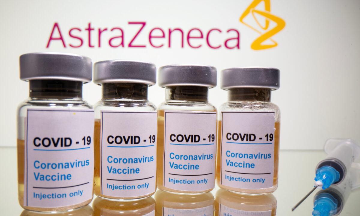 Vials with a sticker reading, "COVID-19 / Coronavirus vaccine / Injection only" and a medical syringe are seen in front of a displayed AstraZeneca logo in this illustration taken Oct. 31, 2020. (Dado Ruvic/Illustration/Reuters)