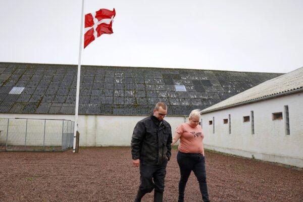 Peter and Trine Brinkmann Nielsen put their flag to half-mast at the Norden mink farm, after the government called for the culling of minks, in Boerglum Kloster, Denmark, on Nov. 5, 2020. (Claus Bjoern Larsen/Ritzau Scanpix via AP)