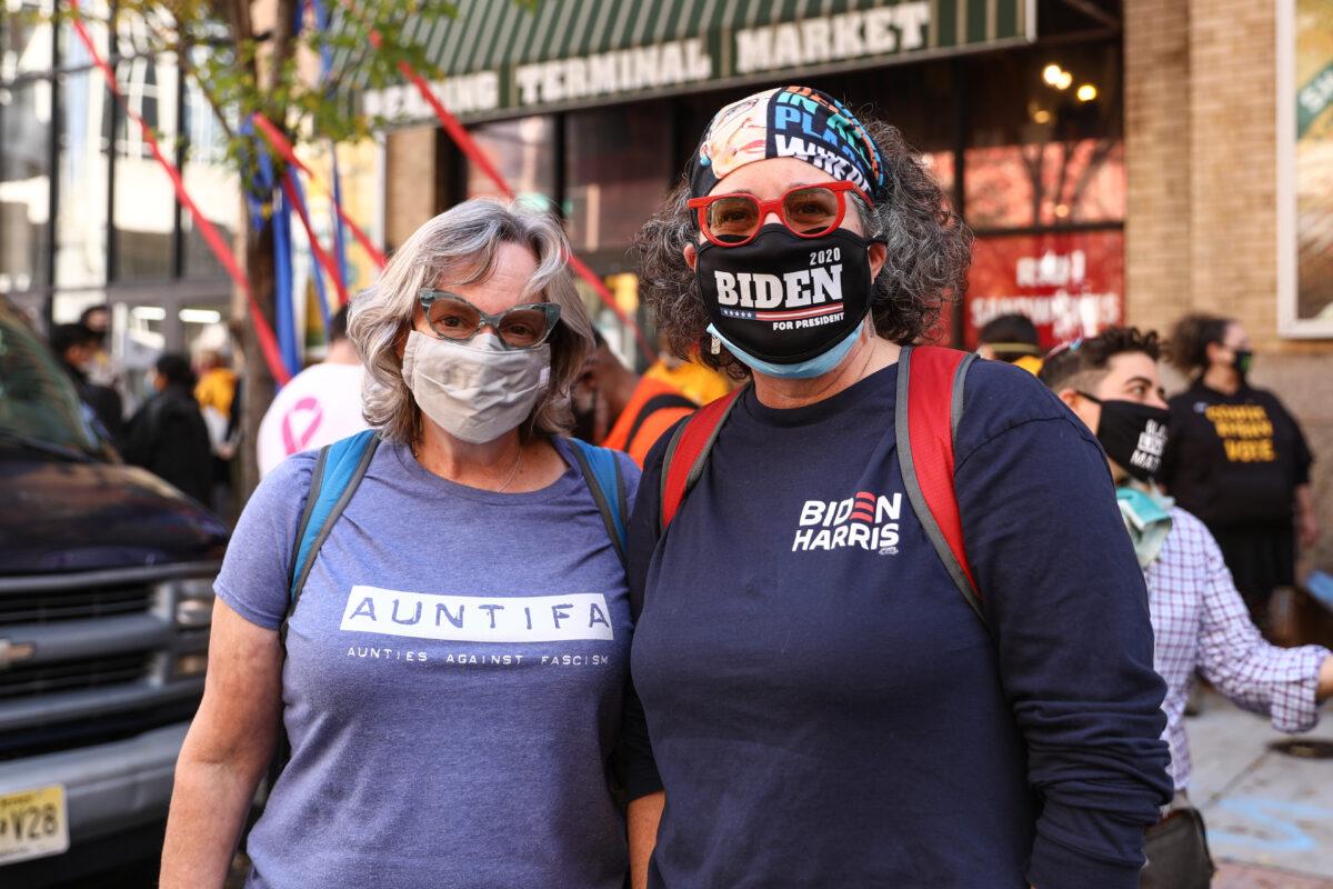 Susan Crawshaw (L) and Sheila Ballen join the pro-Biden protest by the Pennsylvania Convention Center in Philadelphia, Pa., on Nov. 6, 2020. (Charlotte Cuthbertson/The Epoch Times)