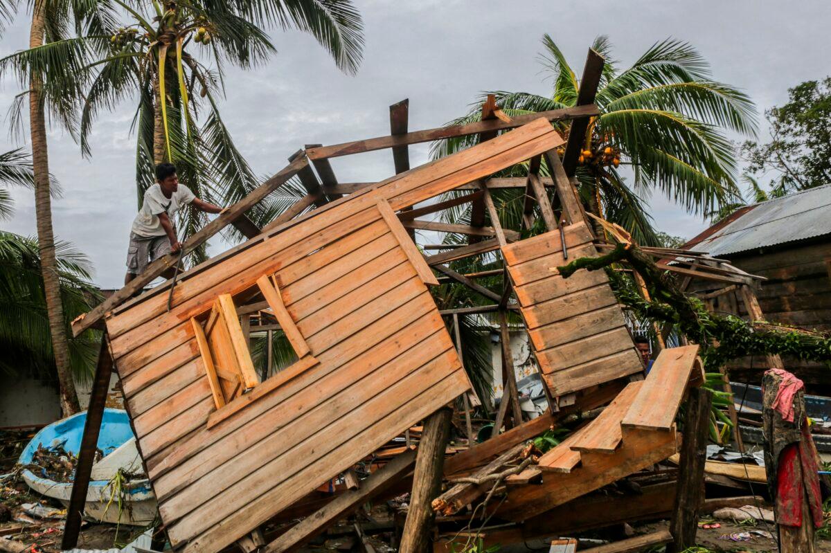 Men fix a small house in "El Muelle" Neighbourhood in Bilwi, Nicaragua on Nov. 5, 2020, after the passage of hurricane Eta. (Inti Ocon/ AFP via Getty Images)