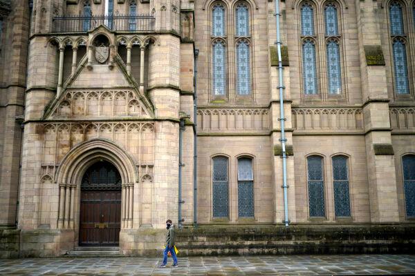 A man walks past Manchester University, in Manchester, England, on Oct. 7, 2020.(Christopher Furlong/Getty Images)