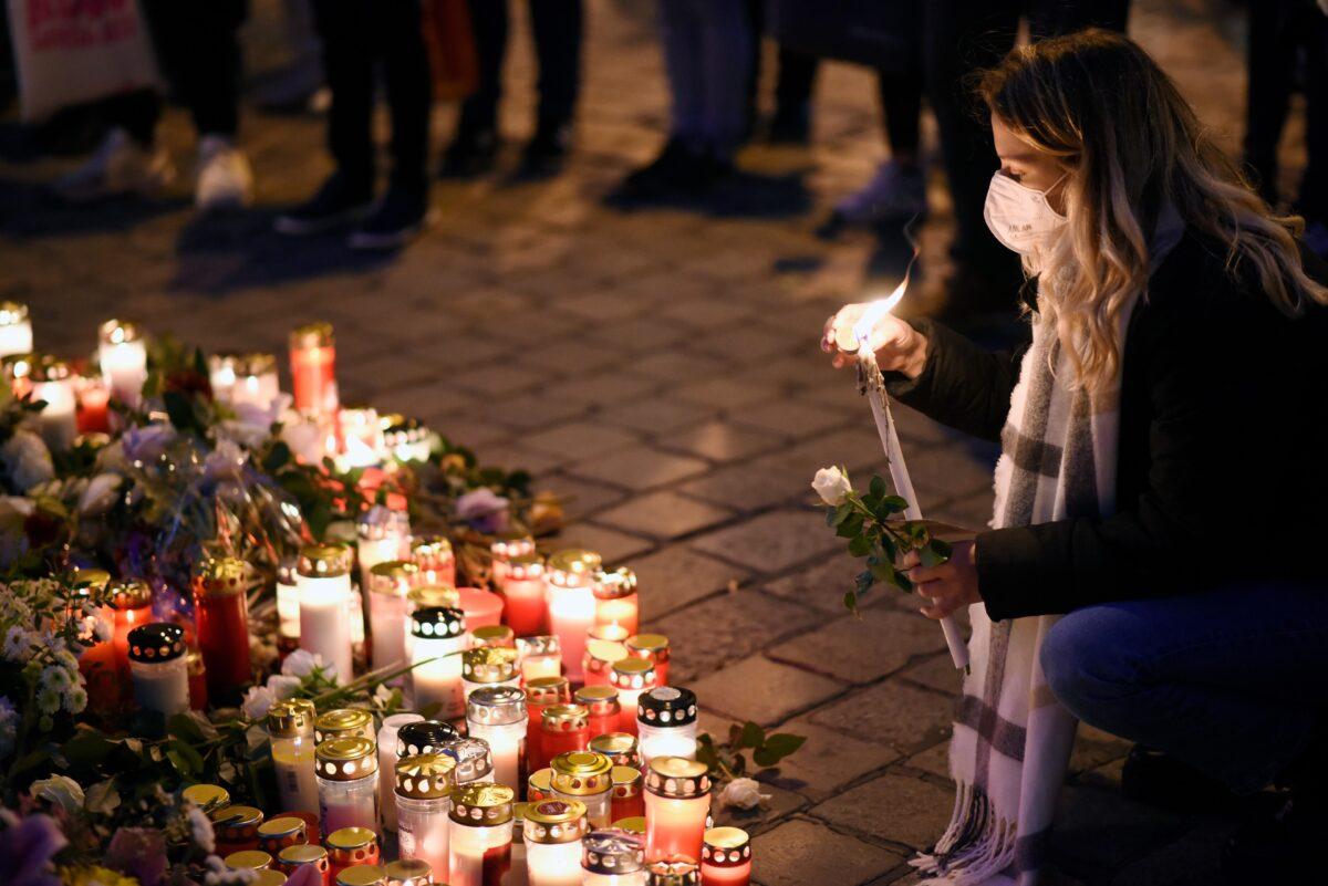 A woman lights a candle at a makeshift memorial at the scene of Monday’s terror attack, in Vienna, on Nov. 05, 2020. (Thomas Kronsteiner/Getty Images)