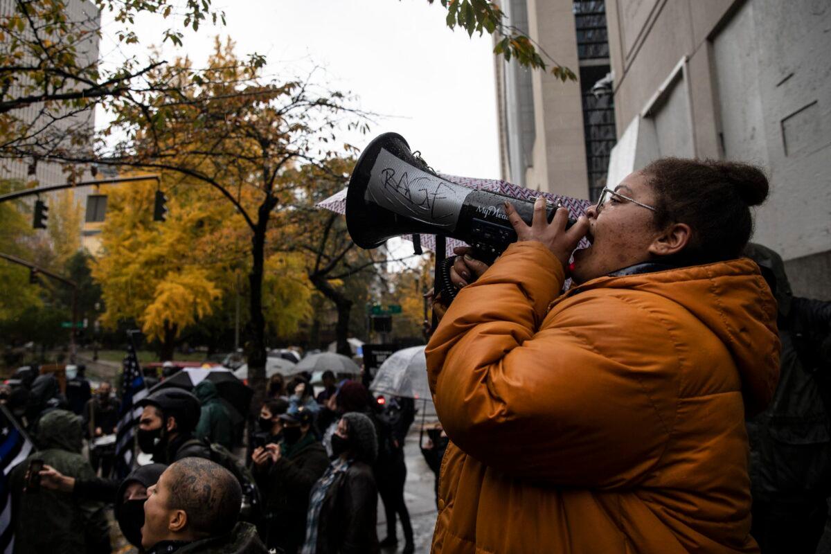 Back the Blue police supporters, left, stand next to Black Lives Matter protesters calling for defunding the police in Portland, Ore., Nov. 5, 2020. (Paula Bronstein/AP Photo)