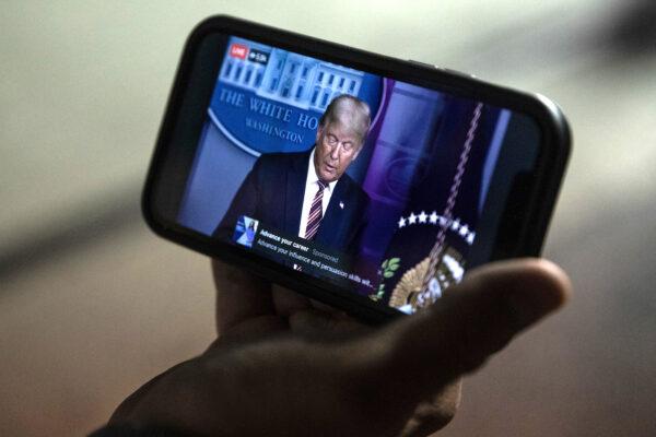 A man watches President Donald Trump hold a news conference as the election in the state is still unresolved in Philadelphia, Pennsylvania on Nov. 5, 2020. (Chris McGrath/Getty Images)