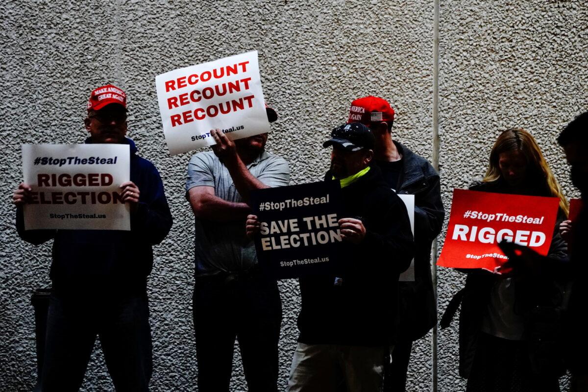 Supporters of President Donald Trump hold placards at a "Stop the Steal" protest outside Milwaukee Central Count, in Wisconsin, on Nov. 5, 2020. (Bing Guan/Reuters)