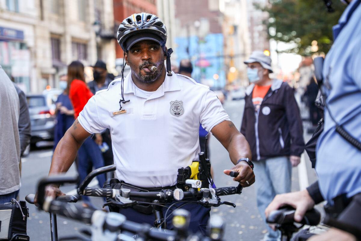 Police officers line up their bikes between the Biden and Trump rallies outside the Pennsylvania Convention Center in Philadelphia on Nov. 6, 2020. (Charlotte Cuthbertson/The Epoch Times)