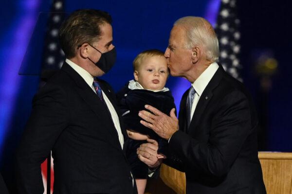 Former Vice President Joe Biden kisses his grandson held by son Hunter Biden after delivering remarks in Wilmington, Delaware, on Nov. 7, 2020. (Jim Watson/AFP via Getty Images)