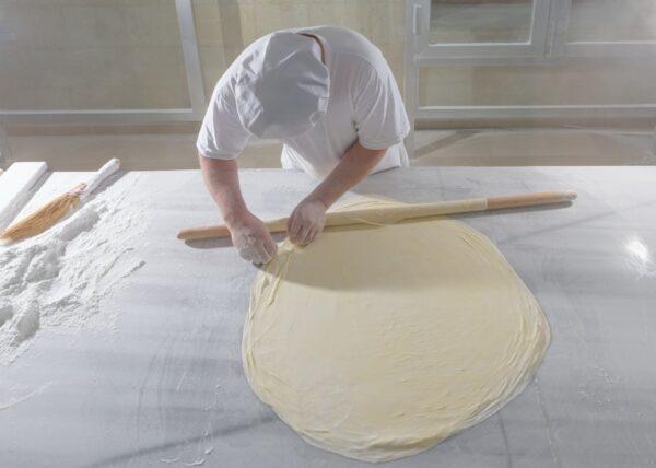 The yufka, fresh pastry sheets, are rolled paper-thin. (Burakguralp/Shutterstock)