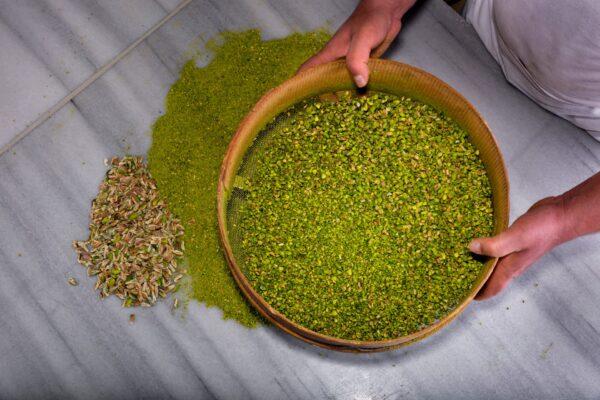 Slightly under-ripe pistachios, "chosen while still on the tree," as Aylin Oney Tan writes, bring a stronger, greener color and flavor to Antep baklava. (Burakguralp/Shutterstock)