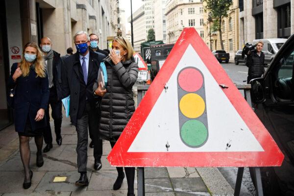 The European Union's chief Brexit negotiator Michel Barnier walks past a traffic light sign in London on Nov. 9, 2020. (Reuters/Toby Melville)