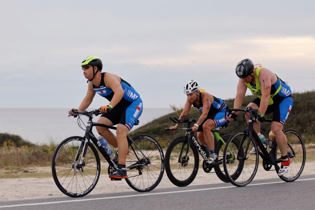 Chris Nikic competes in the bike portion with his guide, Dan Grieb, during IRONMAN Florida on Nov. 7, 2020, in Panama City Beach, Florida. (Michael Reaves/Getty Images)