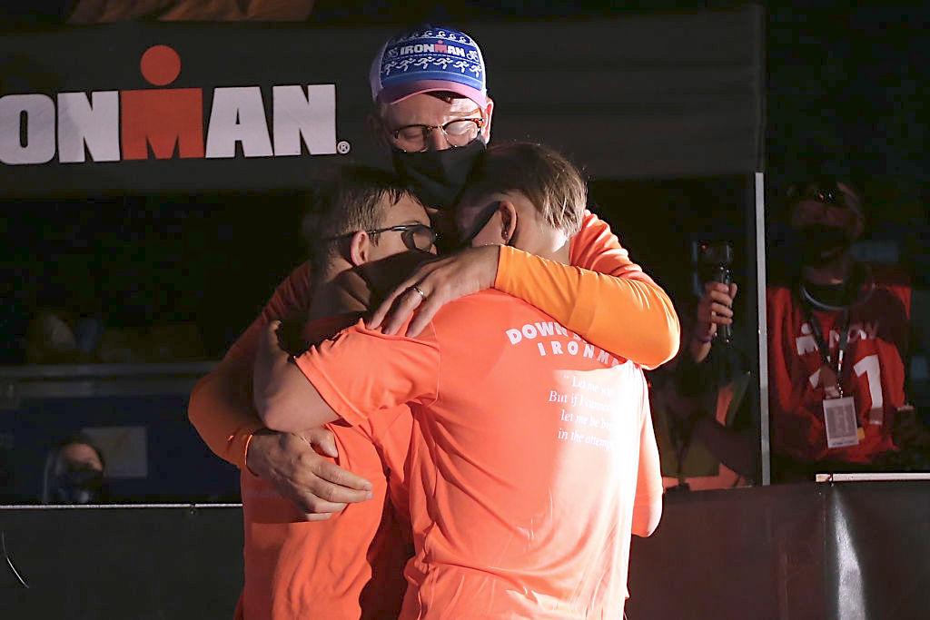 Chris Nikic hugs his father, Nick, and his sister Jacky after finishing the IRONMAN Florida on Nov. 7, 2020, in Panama City Beach, Florida. (Jonathan Bachman/Getty Images)