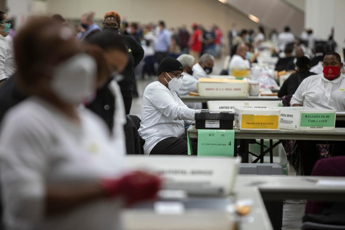 A worker with the Detroit Department of Elections helps process an absentee ballot at the Central Counting Board in the TCF Center in Detroit, Mich., on Nov. 4, 2020. (Elaine Cromie/Getty Images)