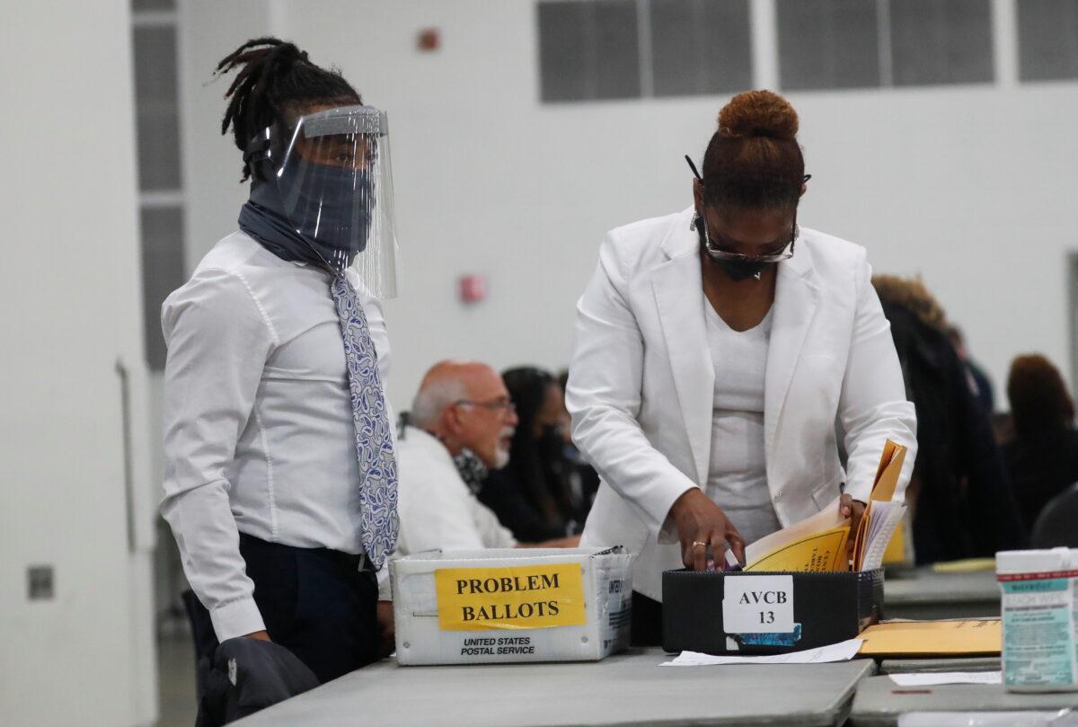 A person reviews ballots as votes continue to be counted at the TCF Center the day after the presidential election, in Detroit, on Nov. 4, 2020. (Shannon Stapleton/Reuters)