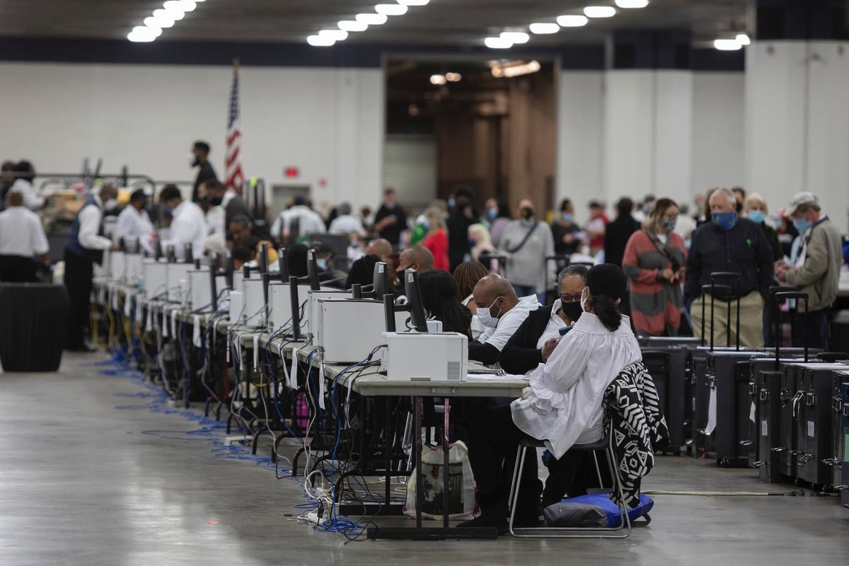 Workers with the Detroit Department of Elections help process absentee ballots at the Central Counting Board in the TCF Center in Detroit, Mich., on Nov. 4, 2020. (Elaine Cromie/Getty Images)