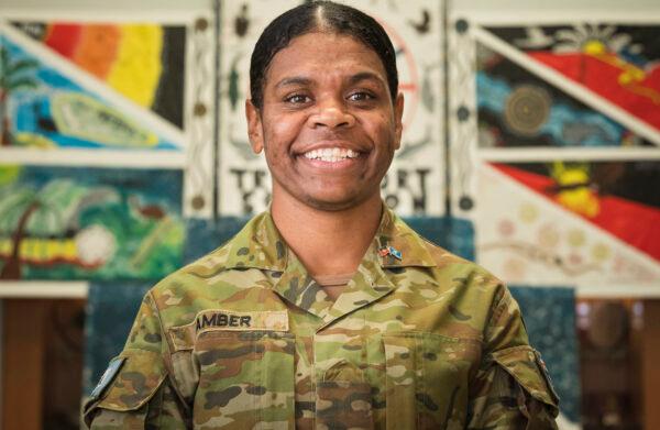 3rd Combat Service Support Battalion Driver Specialist Private Pamela Amber stands by 9 Transport Squadron's artwork created for the National Reconciliation Week at Lavarack Barracks, Townsville. (PTE Madhur Chitnis via ADF)