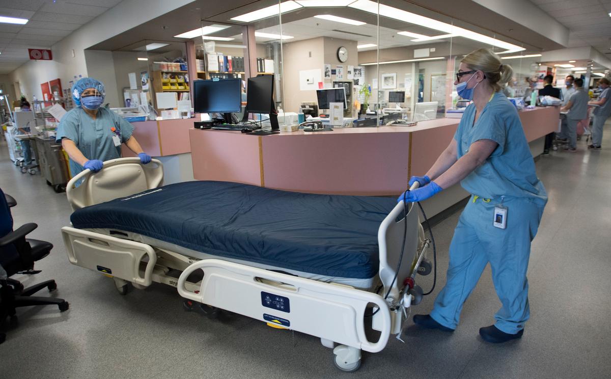 A bed in need of cleaning is moved in the COVID-19 intensive care unit at St. Paul's hospital in downtown Vancouver, Canada, on April 21, 2020. (Jonathan Hayward/The Canadian Press)