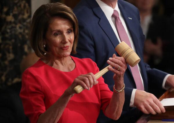 Speaker of the House Nancy Pelosi (D-Calif.) smiles after receiving the gavel from Rep. Kevin McCarthy (R-Calif.) after being elected as the next speaker of the House during the first session of the 116th Congress at the U.S. Capitol in Washington on Jan. 3, 2019. (Win McNamee/Getty Images)