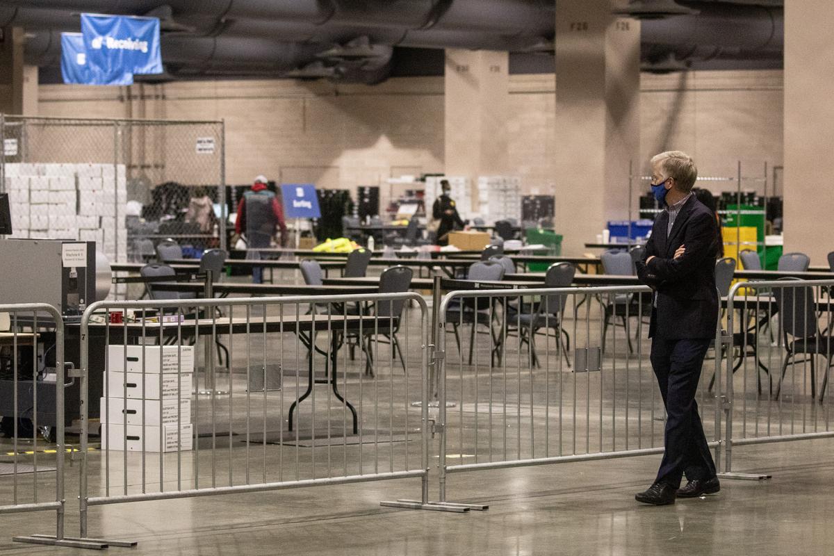 A man watches on from the observers area as election workers count ballots at the Philadelphia Convention Center in Philadelphia, Pa., on Nov. 6, 2020. (Chris McGrath/Getty Images)