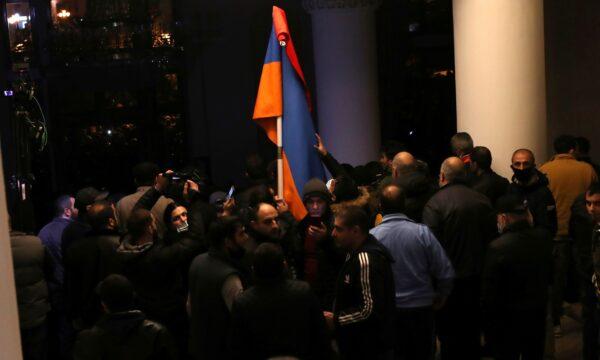 People gather at the government house after Armenian Prime Minister Nikol Pashinyan said he had signed an agreement with leaders of Russia and Azerbaijan to end the war, in Yerevan, Armenia, on Nov. 10, 2020. (Hayk Baghdasaryan/Photolure via Reuters)