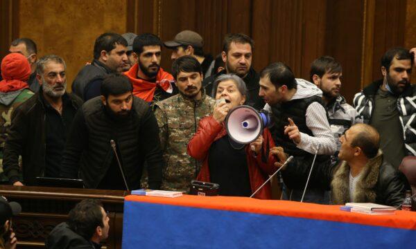 People storm the parliament, after Armenian Prime Minister Nikol Pashinyan said he had signed an agreement with leaders of Russia and Azerbaijan to end the war, in Yerevan, Armenia, on Nov. 10, 2020. (Vahram Baghdasaryan/Photolure via Reuters)