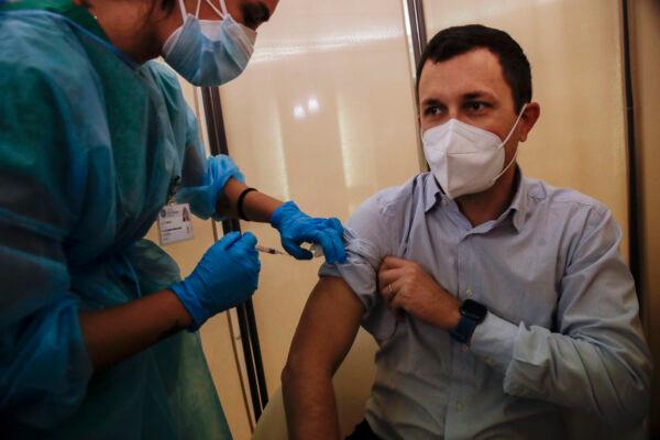A man receives a flu vaccine at the Museum of science and technology in Milan, Italy on Nov. 4, 2020. (Luca Bruno/The Associated Press)