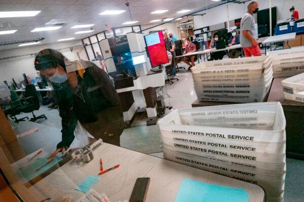 Poll workers count ballots inside the Maricopa County Election Department in Phoenix, Ariz., on Nov. 5, 2020 (Olivier Touron/AFP via Getty Images)