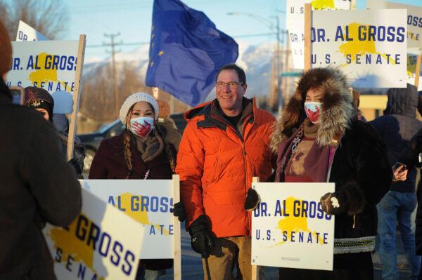 Dr. Al Gross (C)  pauses for a photo with supporters during a sign-waving along Seward Highway, on Election Day in Anchorage, Alaska, on Nov. 3, 2020. Gross dropped out of the race to fill the unexpired term of U.S. Rep. Don Young (R-Alaska) in the regular primary election on Aug. 16, 2022. (Michael Dinneen/AP Photo)